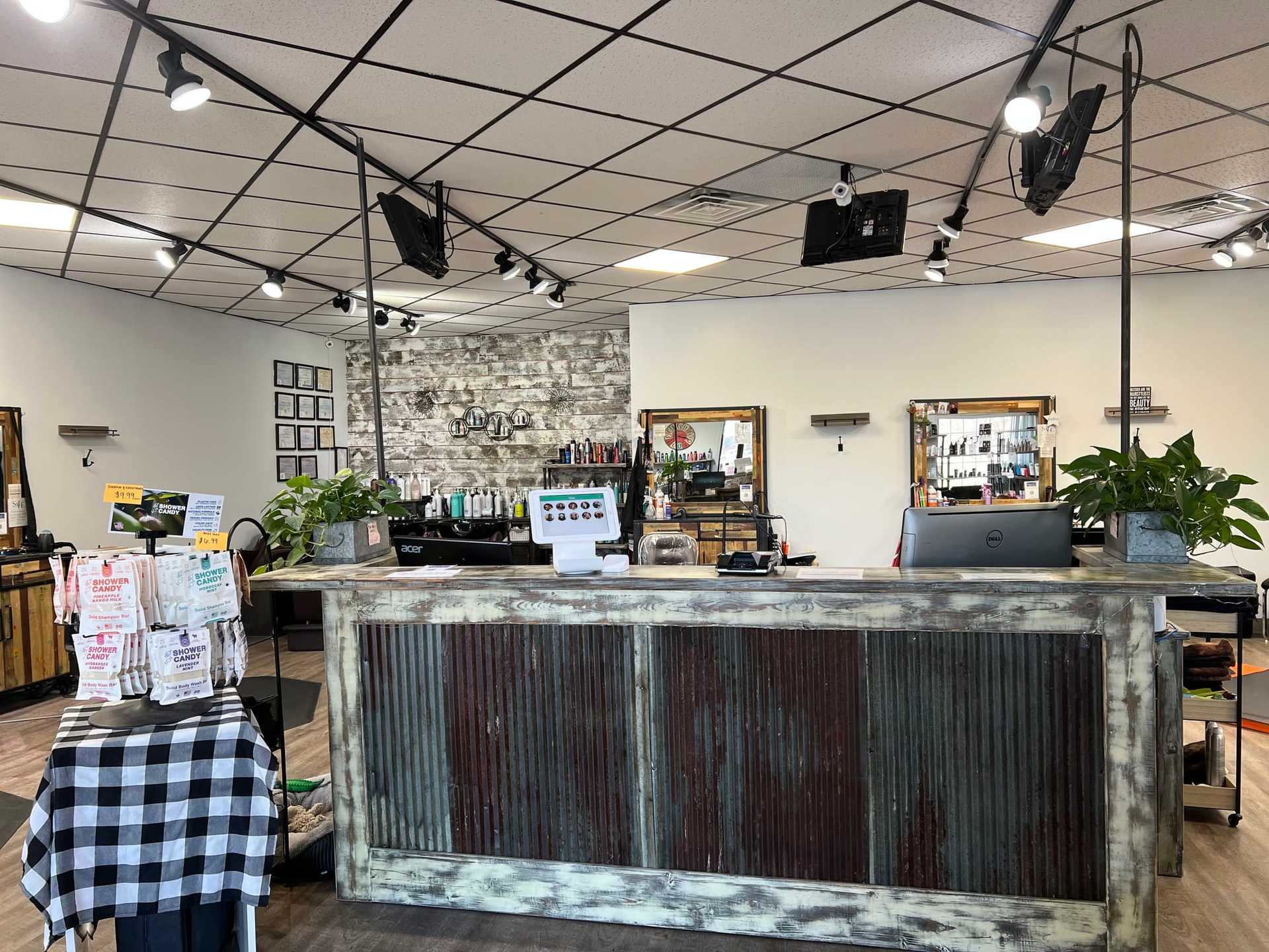 Interior of a modern salon with reception desk and products displayed.